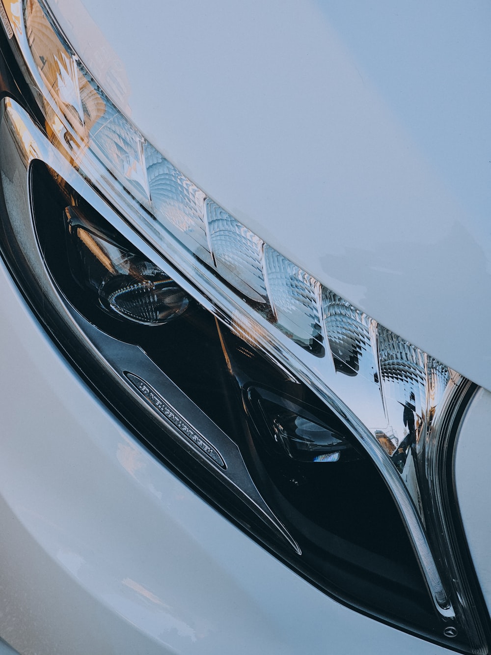a close up of a white car headlight