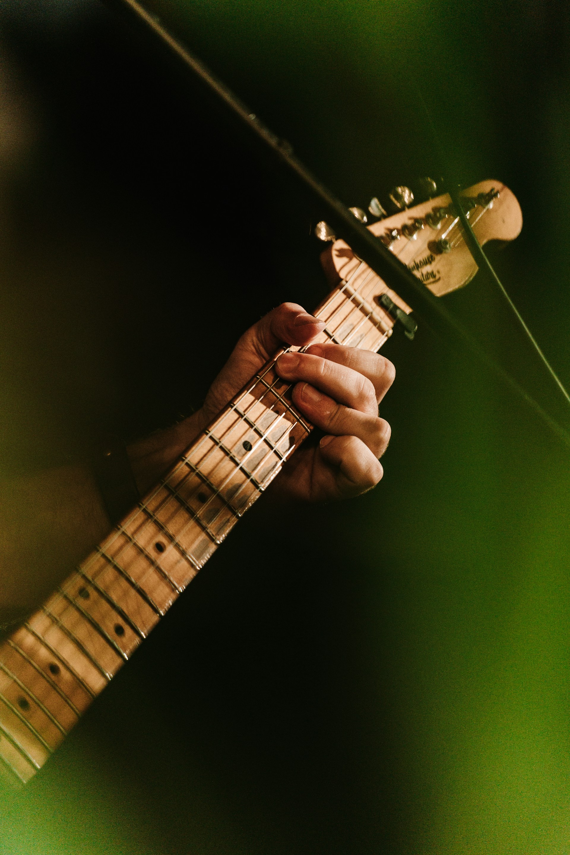 a close up of a person playing a guitar