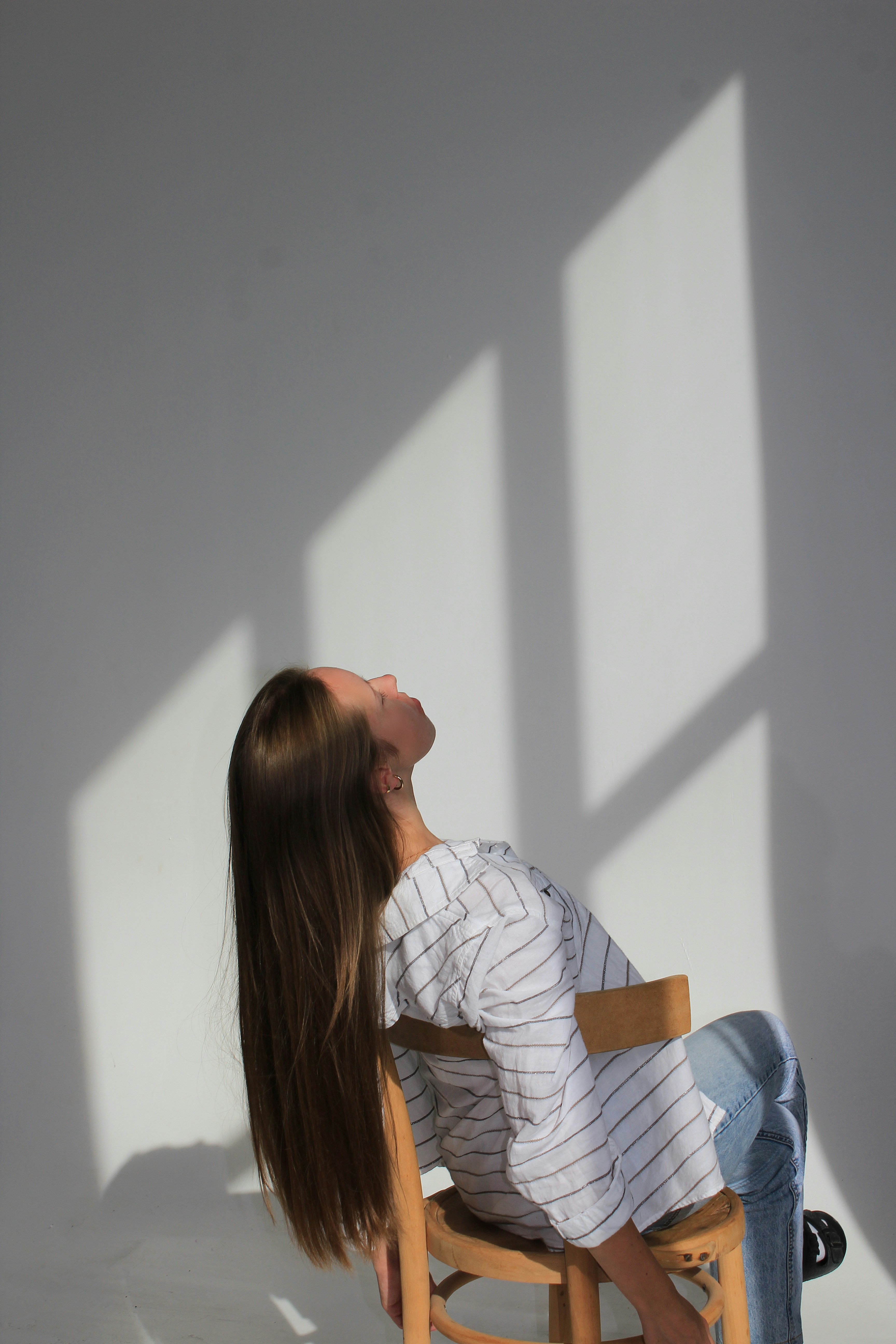 a woman sitting in a chair with her eyes closed