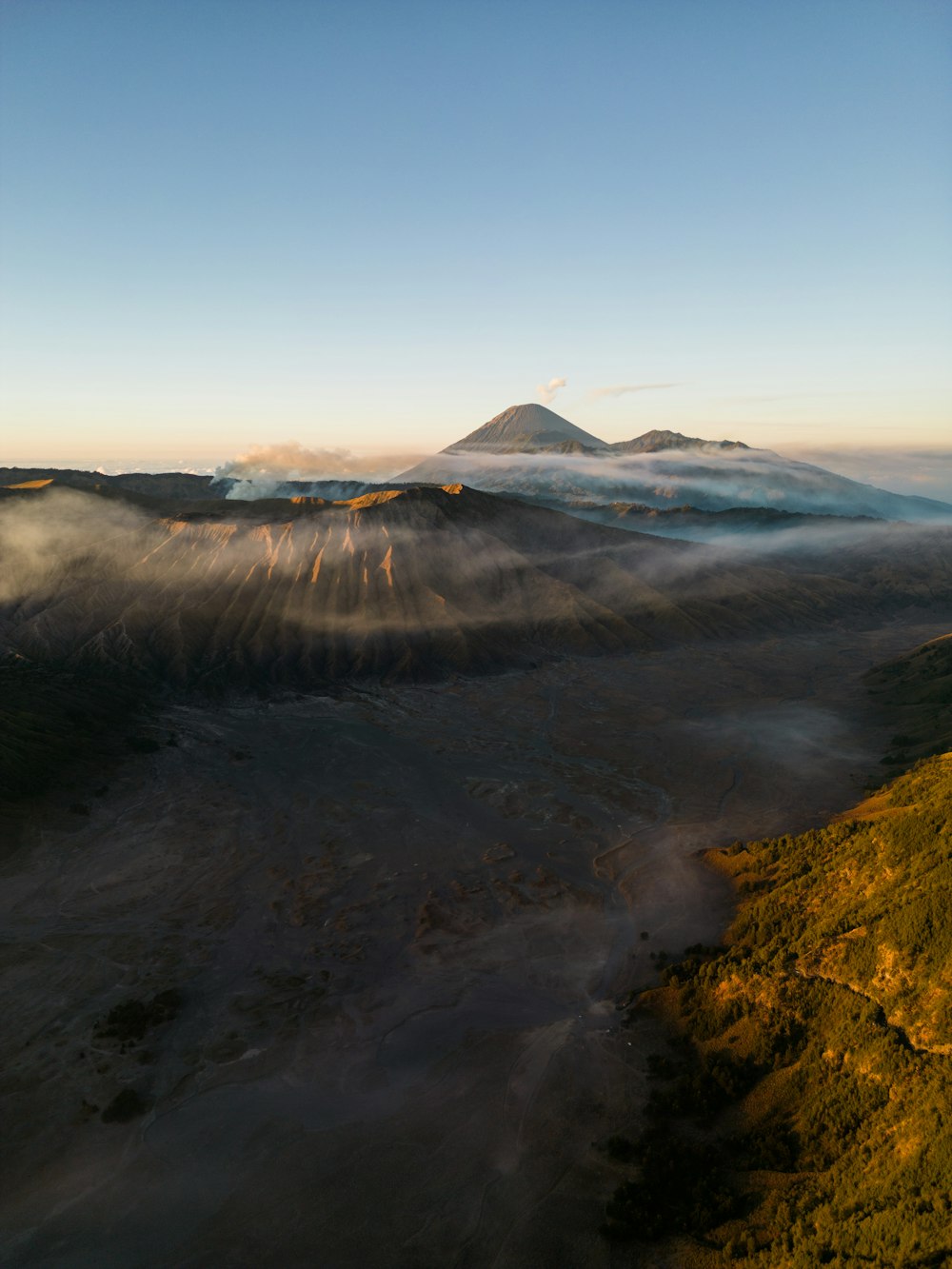 a view of a mountain covered in fog