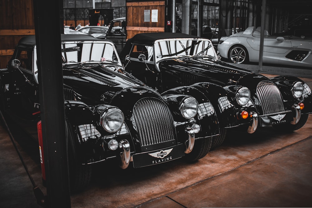 a row of classic cars parked next to each other