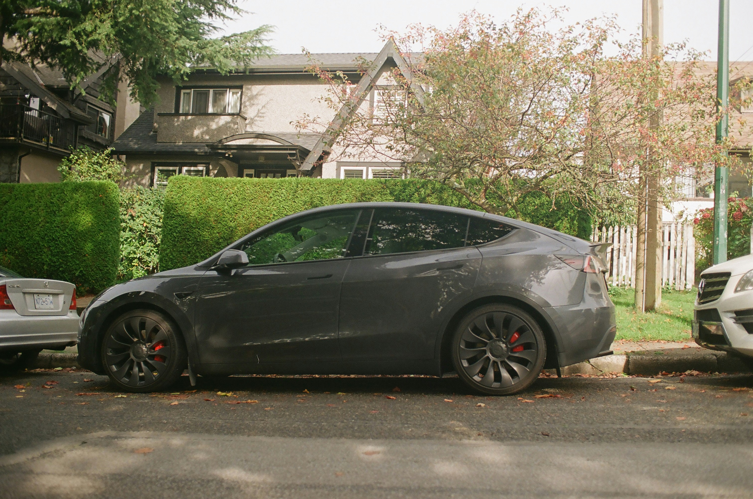 Used Tesla Model 3 parked on a city street, representing affordable secondhand Teslas
