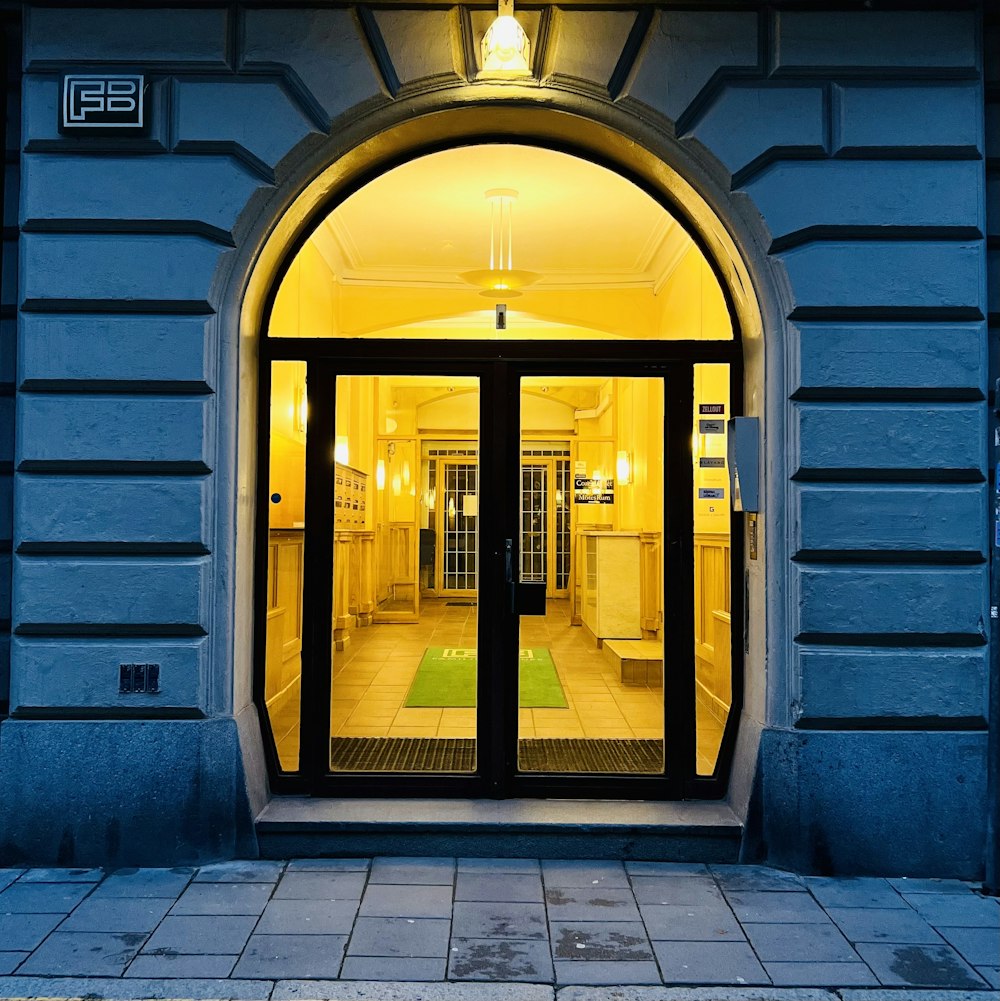 the entrance to a building lit up at night