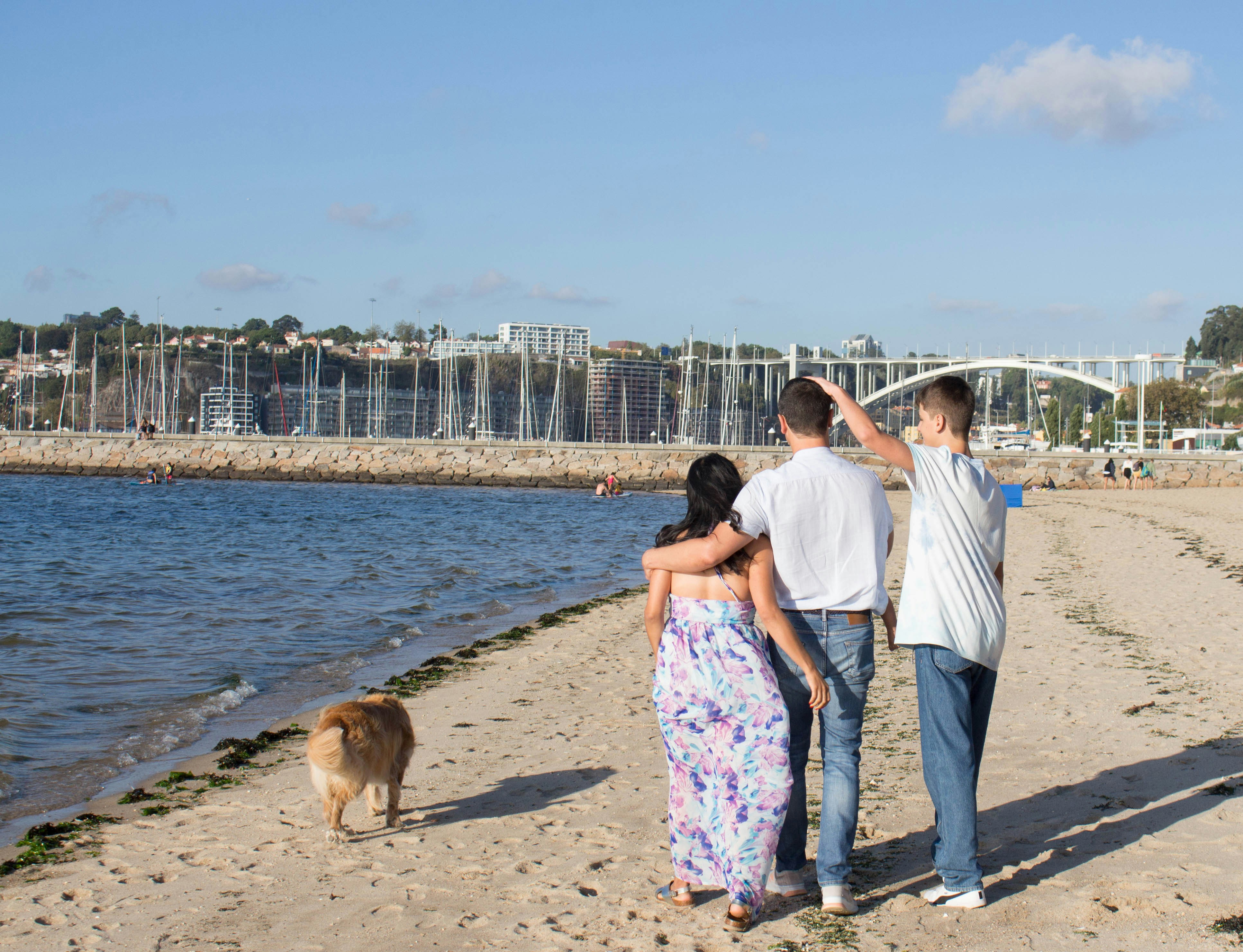 a group of people standing on top of a sandy beach