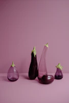 Deep purple eggplants with smooth shiny skin arranged artfully.