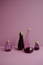 a group of three vases sitting on top of a table