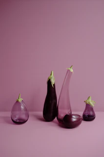 Deep purple eggplants with smooth shiny skin arranged artfully.