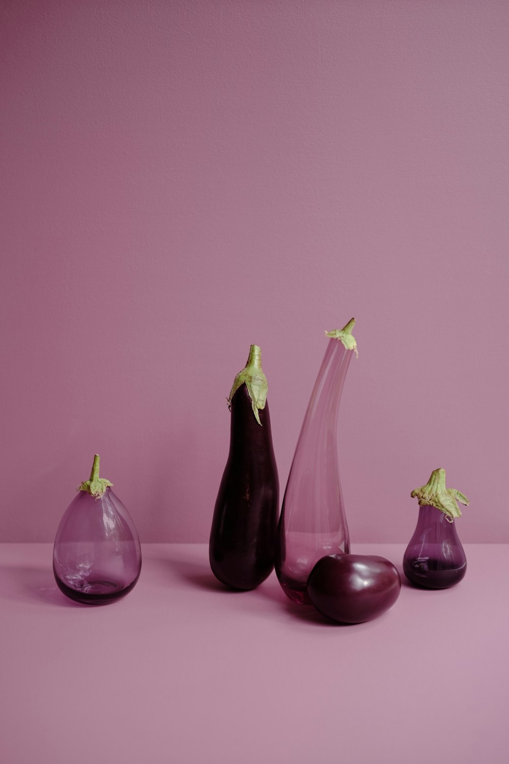 a group of three vases sitting on top of a table