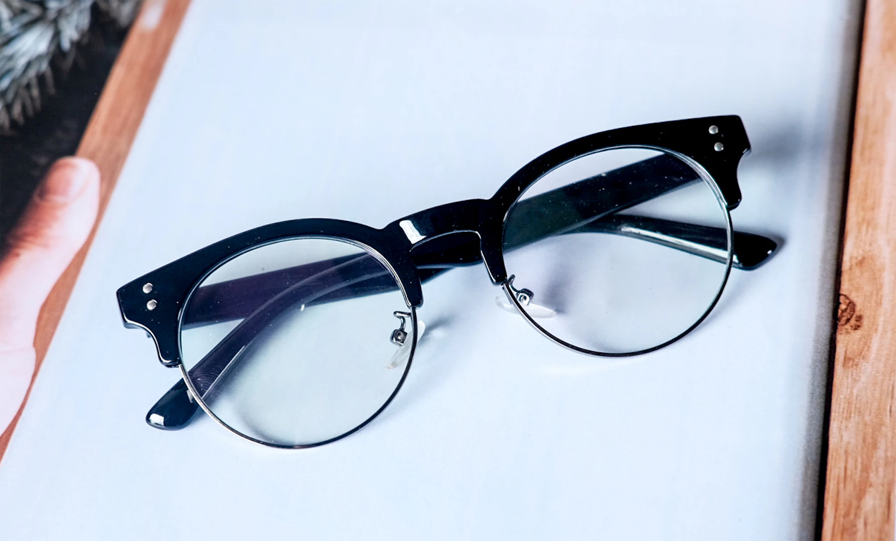 Eyeglasses on a white desk with an eyewear shopping setup