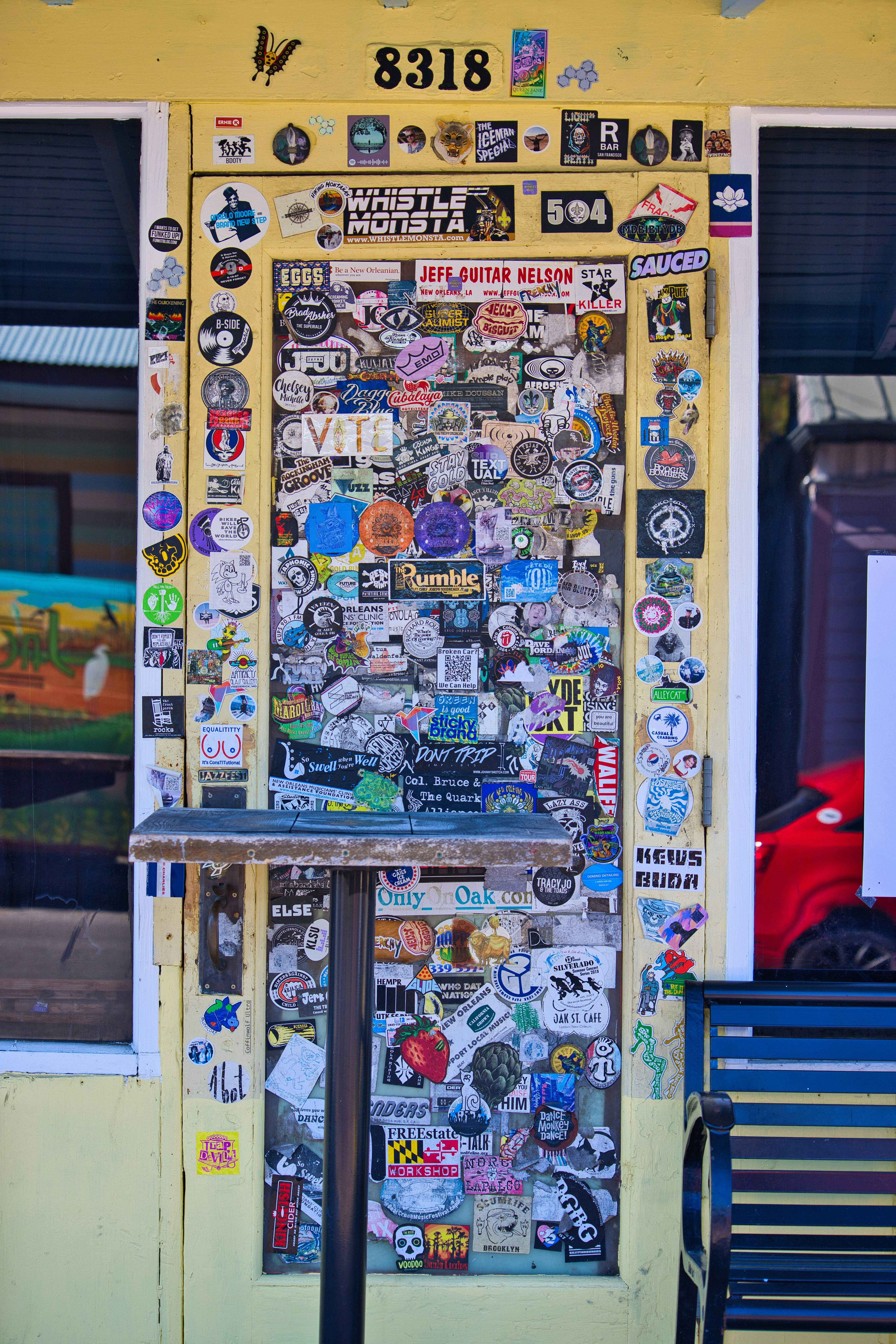 a yellow building with a bunch of stickers on it