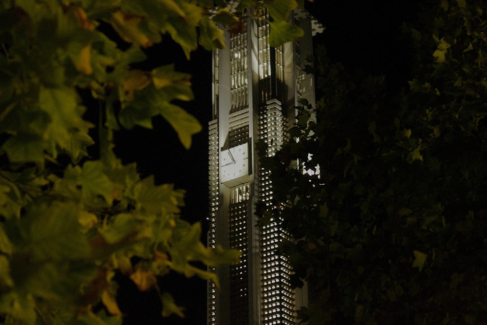 a tall clock tower towering over a city at night