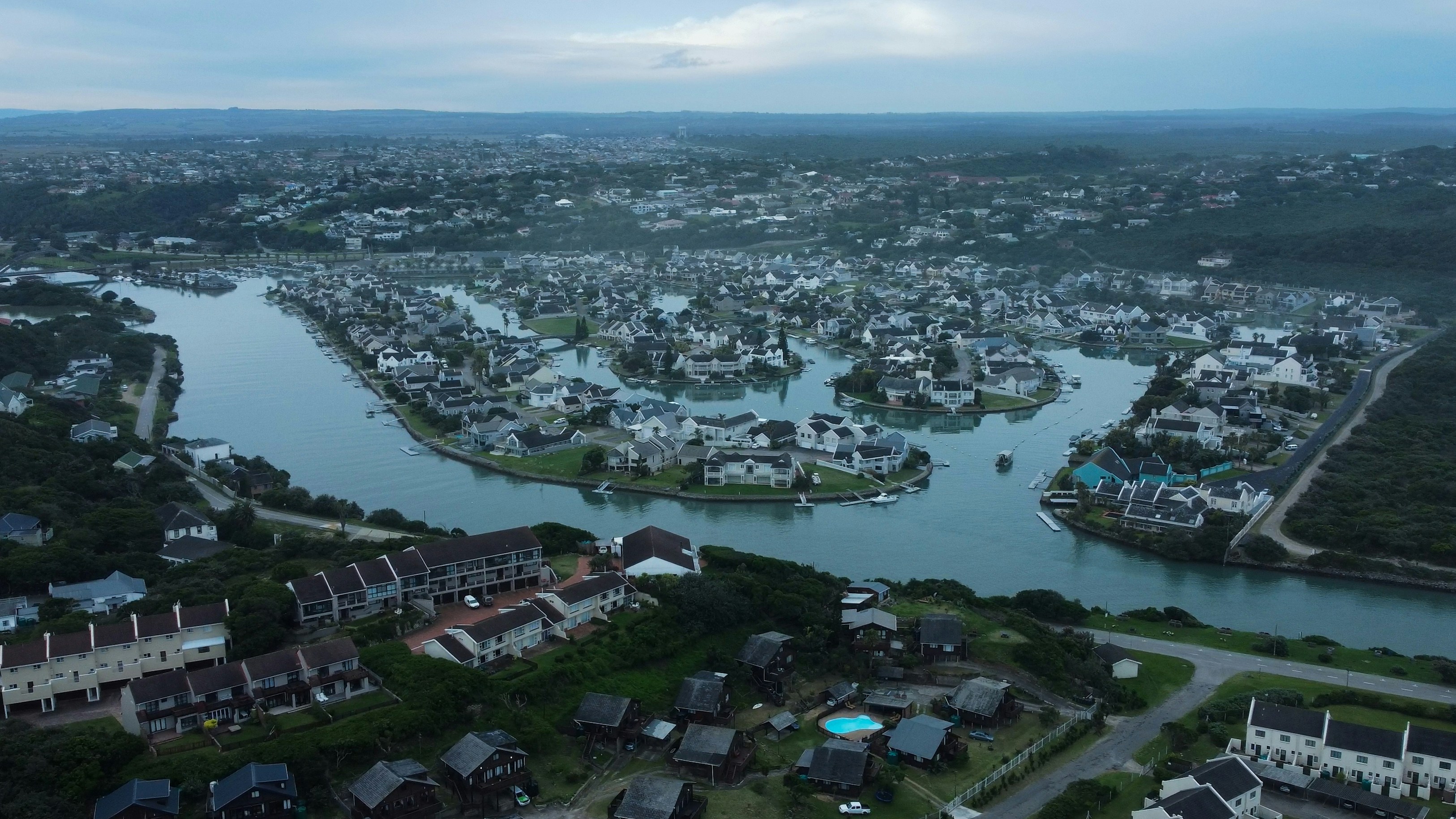 an aerial view of a river running through a city