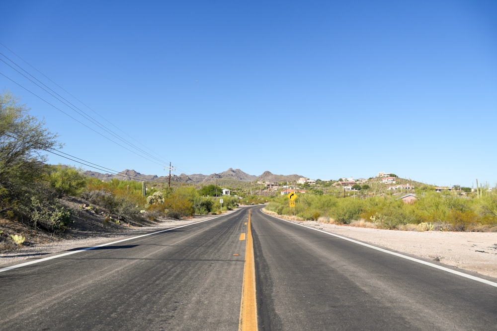 an empty road in the middle of a desert