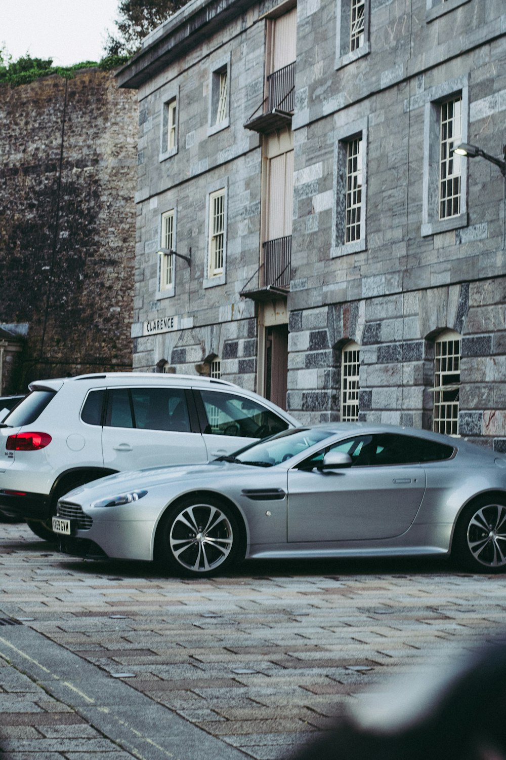 a couple of cars parked next to each other on a street