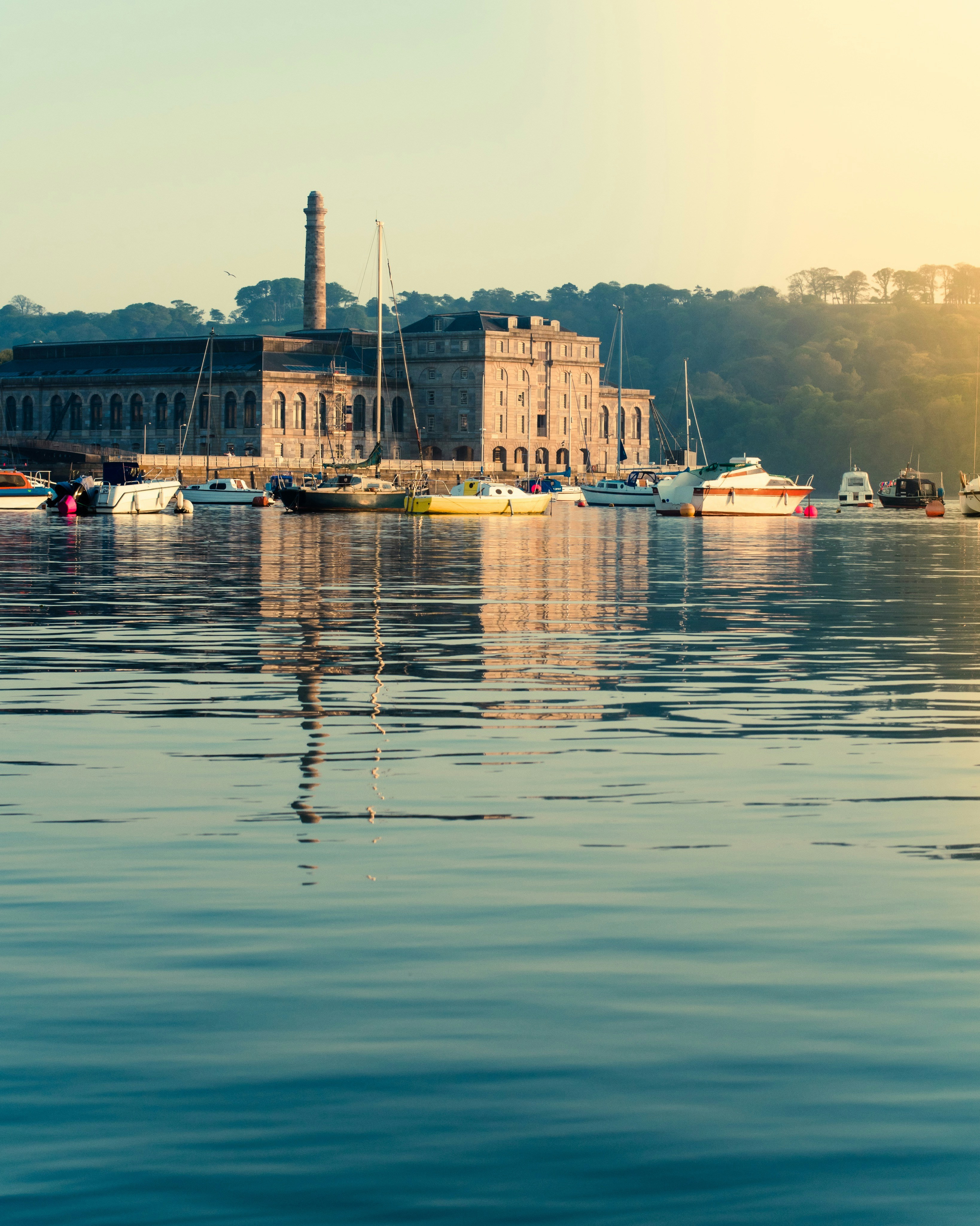 a body of water with boats and a building in the background