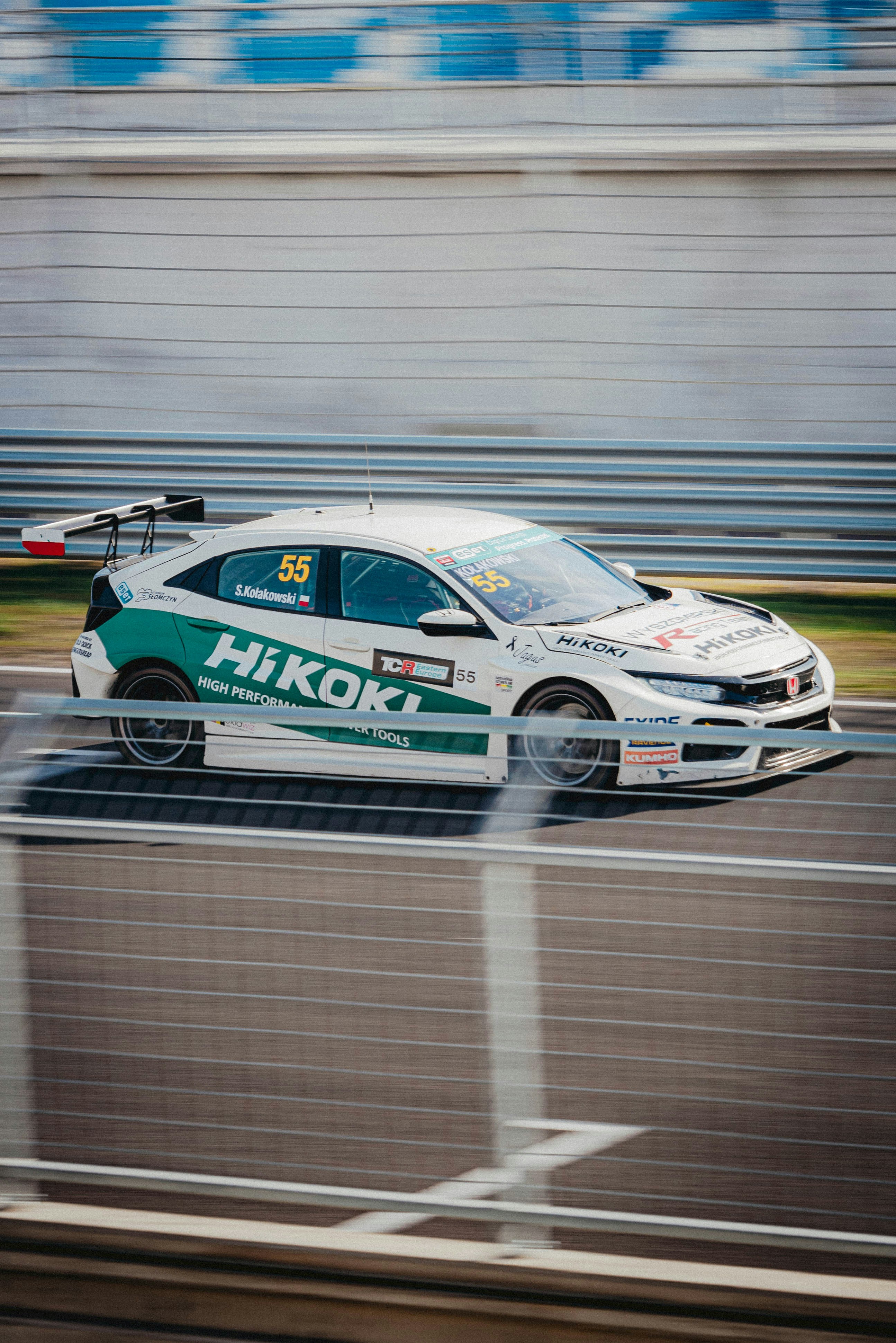 A white car driving down a race track photo – Free Hungary Image on ...