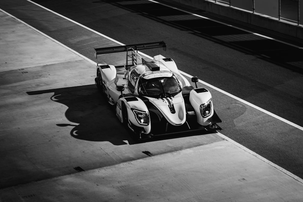 a black and white photo of a race car