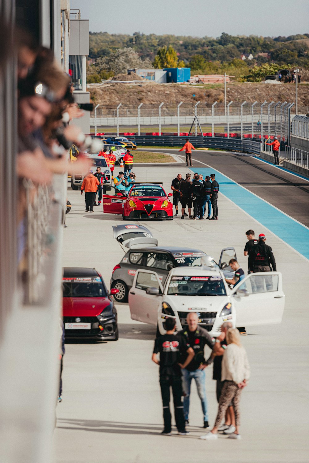 a group of people standing on a race track