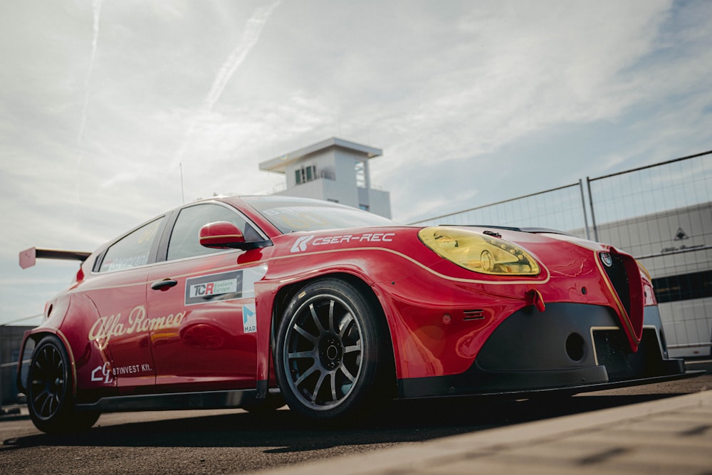 a red sports car parked in front of a building