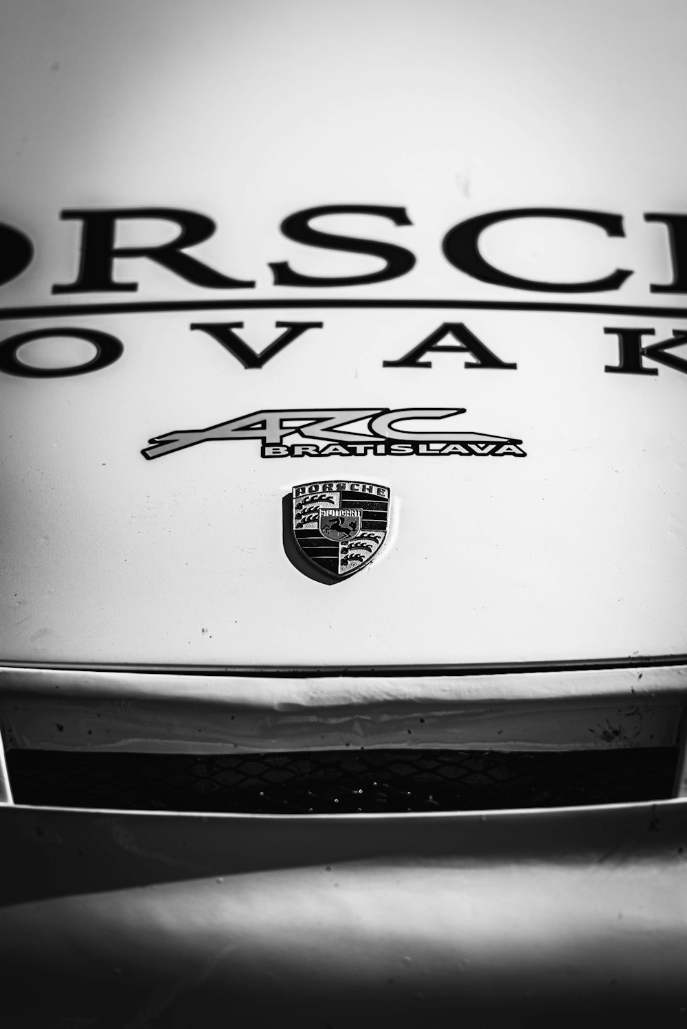 a black and white photo of a porsche logo