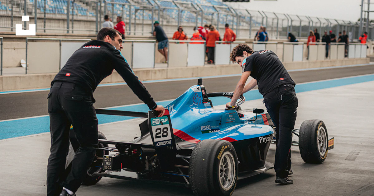 2 Man Racing Two men working on a race car on a track photo – Free Hungary Image on ...
