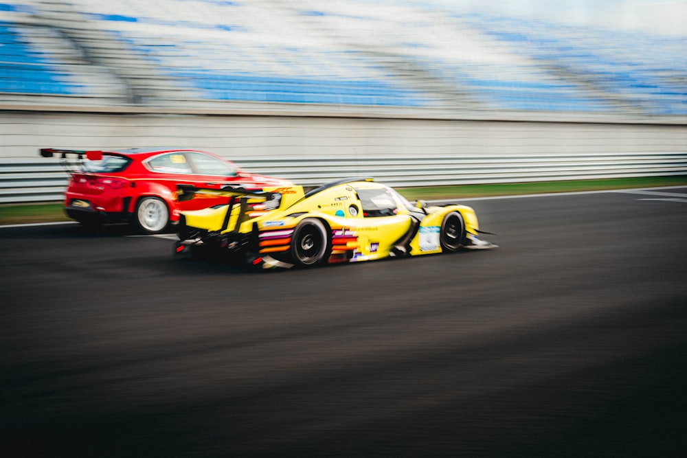 a yellow race car driving down a race track