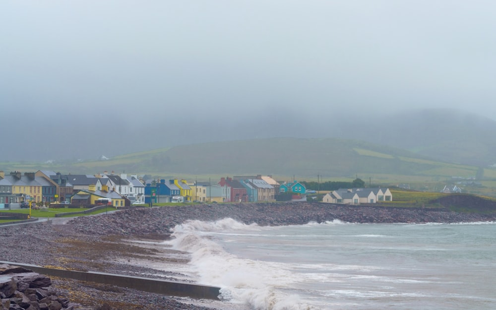 a large body of water with houses in the background