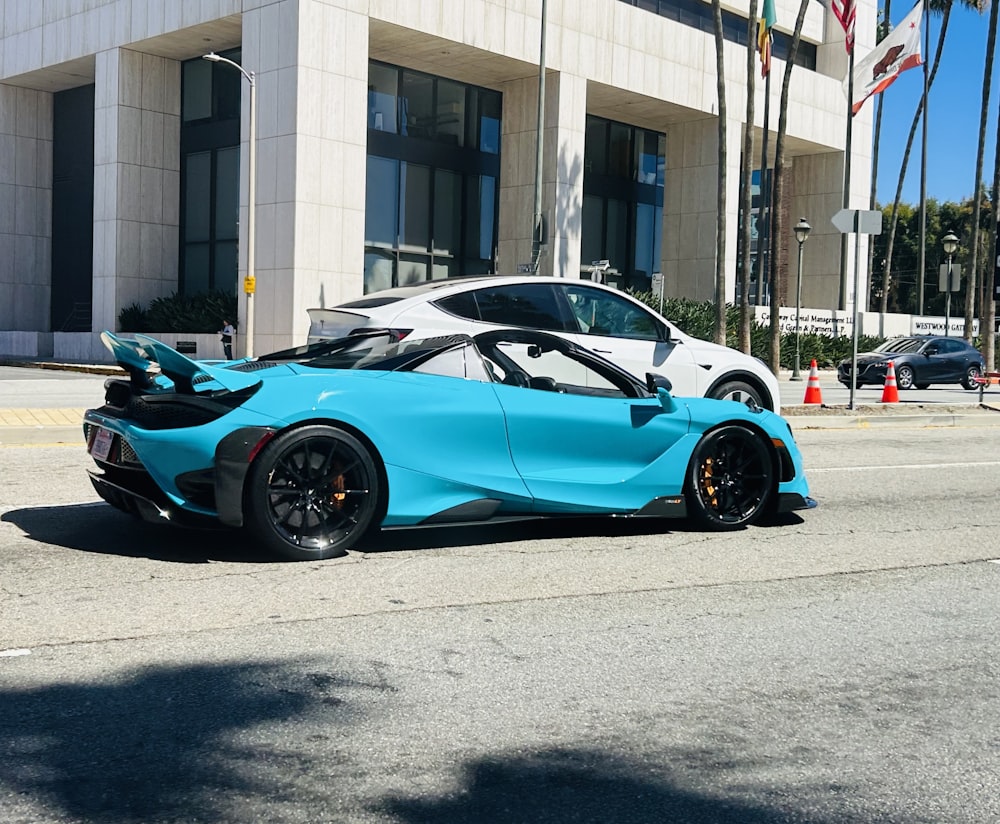 a blue sports car parked on the side of the road