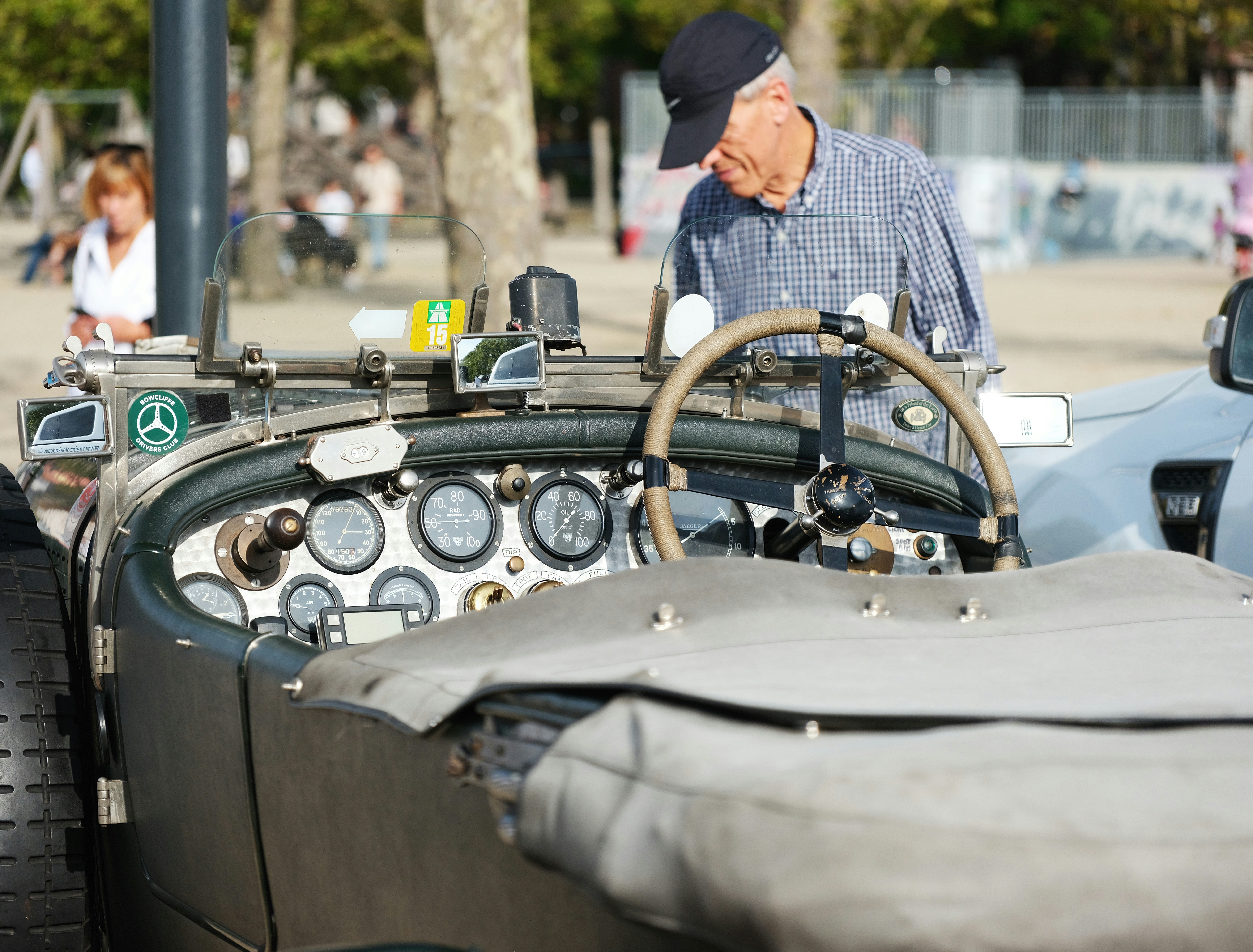 a man standing next to a car with a steering wheel