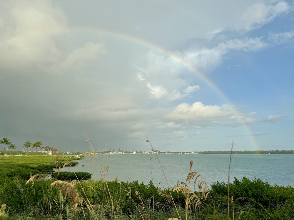 a rainbow in the sky over a body of water