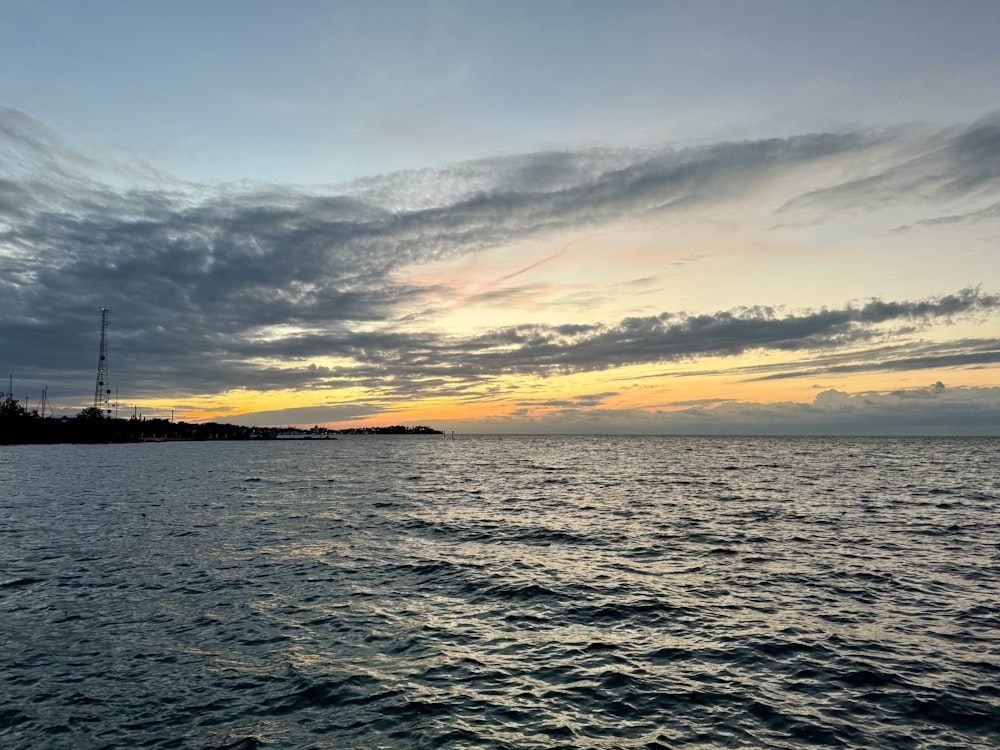 a body of water with a sky in the background