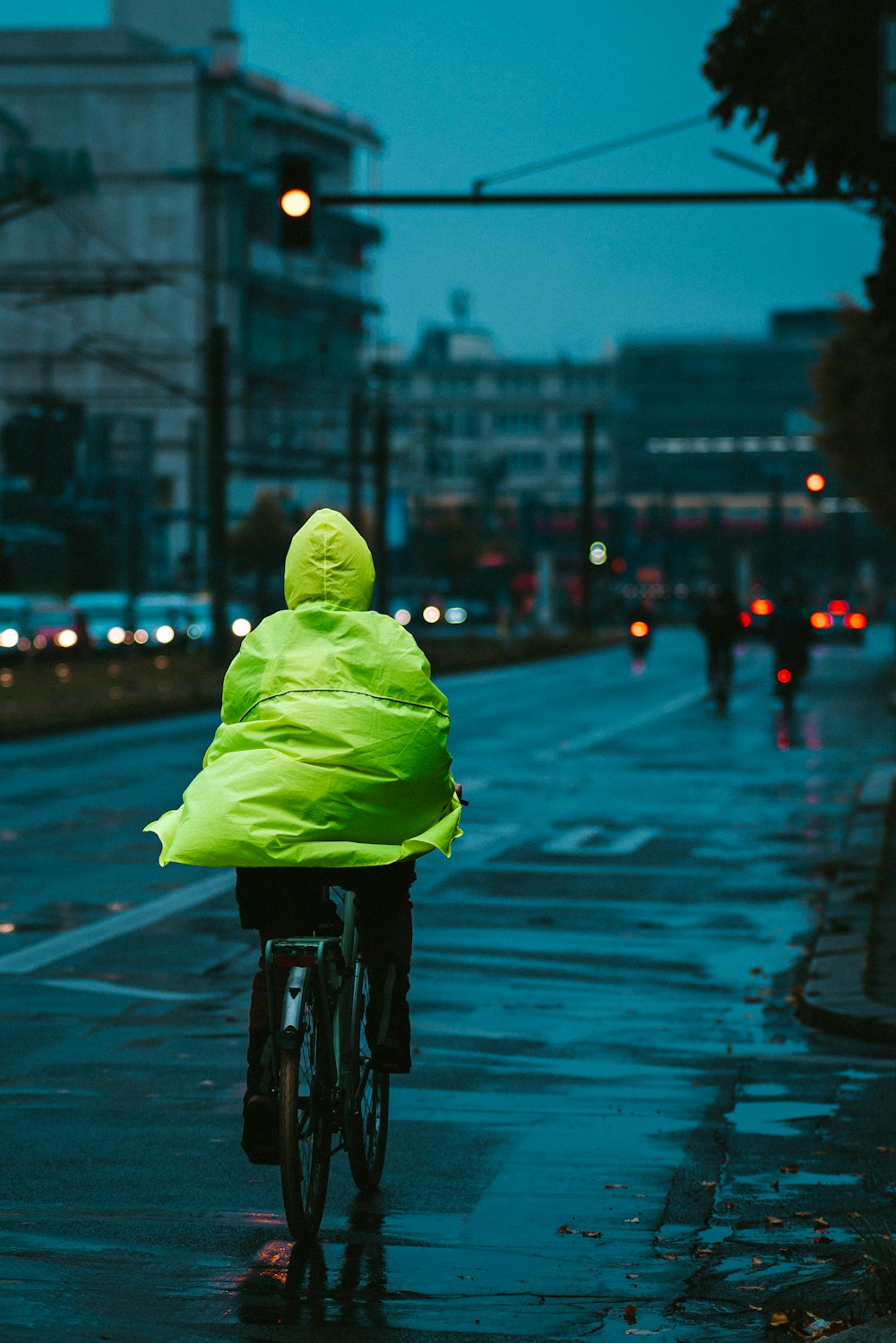 a person riding a bike down a rain soaked street