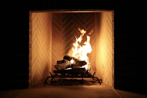 a fire burning in a fireplace in a dark room
