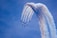 a group of jets flying through a blue sky