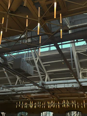 Bright warehouse lighting fixtures installed on high ceilings for optimal visibility.