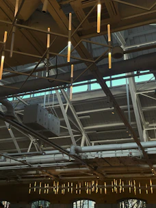 Bright warehouse lighting fixtures installed on high ceilings for optimal visibility.