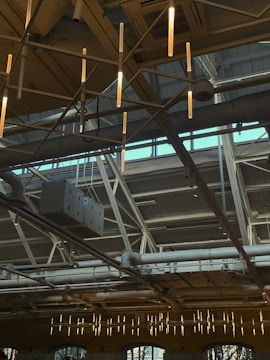 Professional installing drywall in a bright commercial space