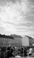 A bustling street market in a European city filled with colorful stalls.