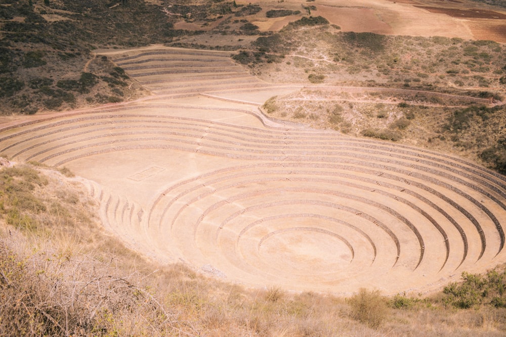 a large circular structure in the middle of a field