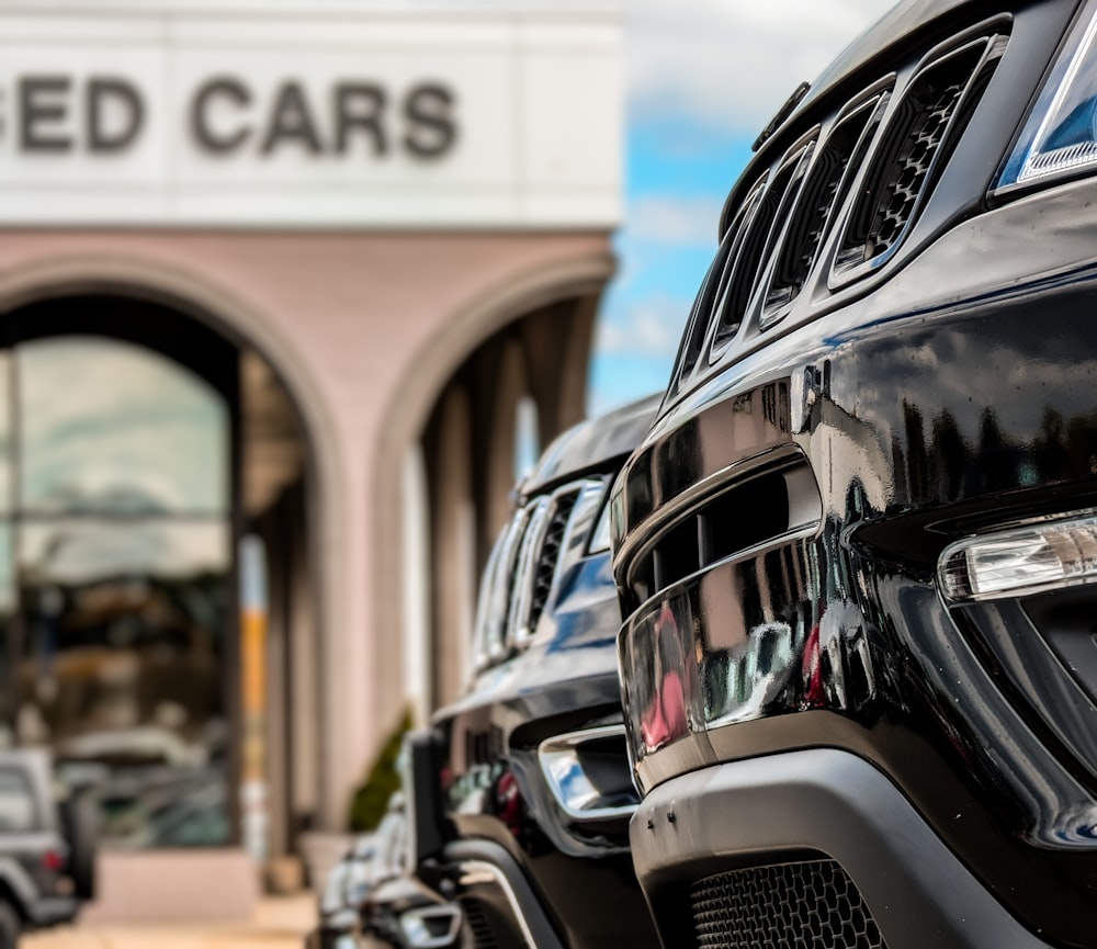 a row of parked cars in front of a building