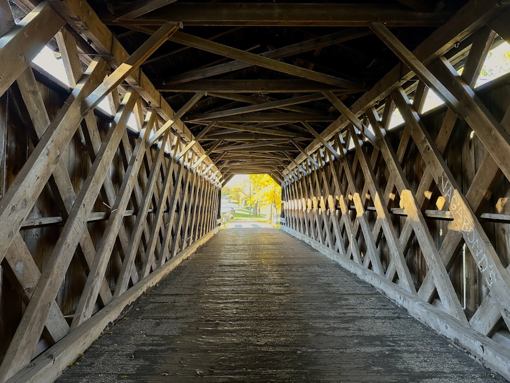 a wooden bridge that has a light at the end of it