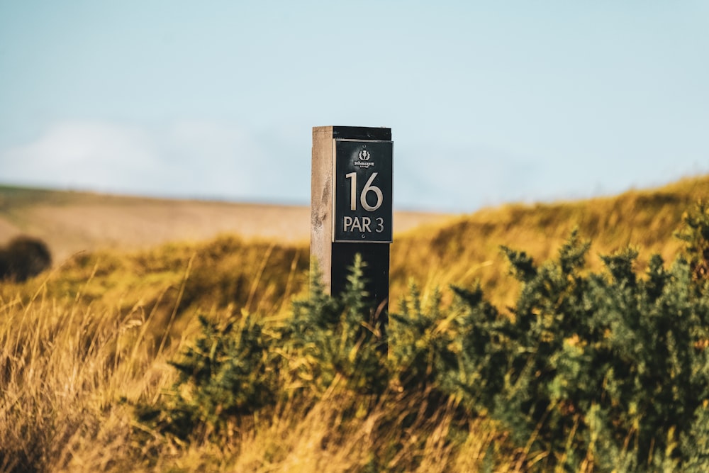 a sign in the middle of a grassy field