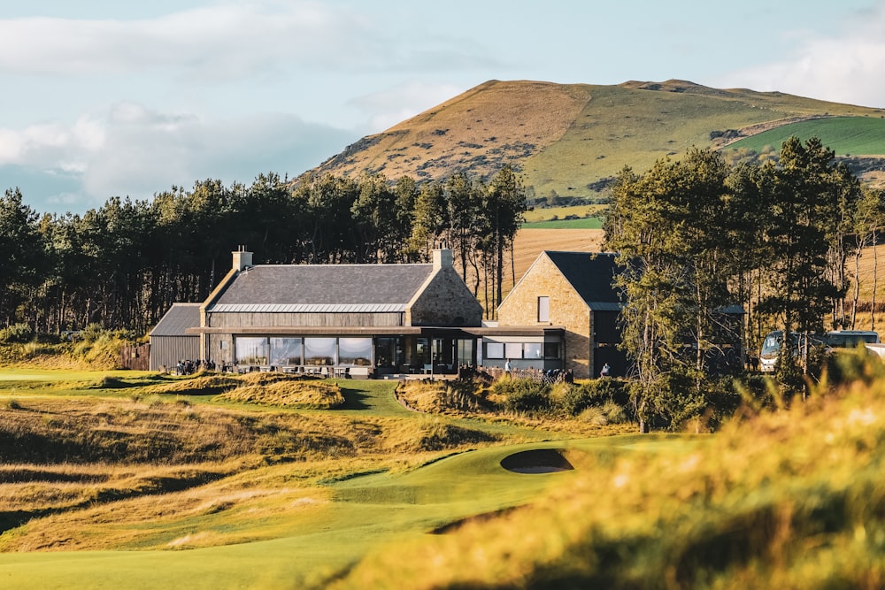 a golf course with a house in the background