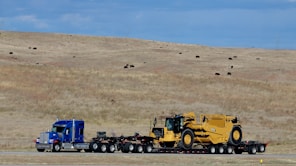 a semi truck hauling a tractor trailer down a road