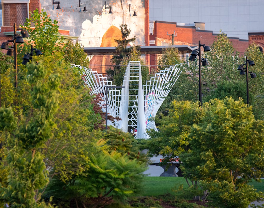 a large white sculpture in the middle of a park