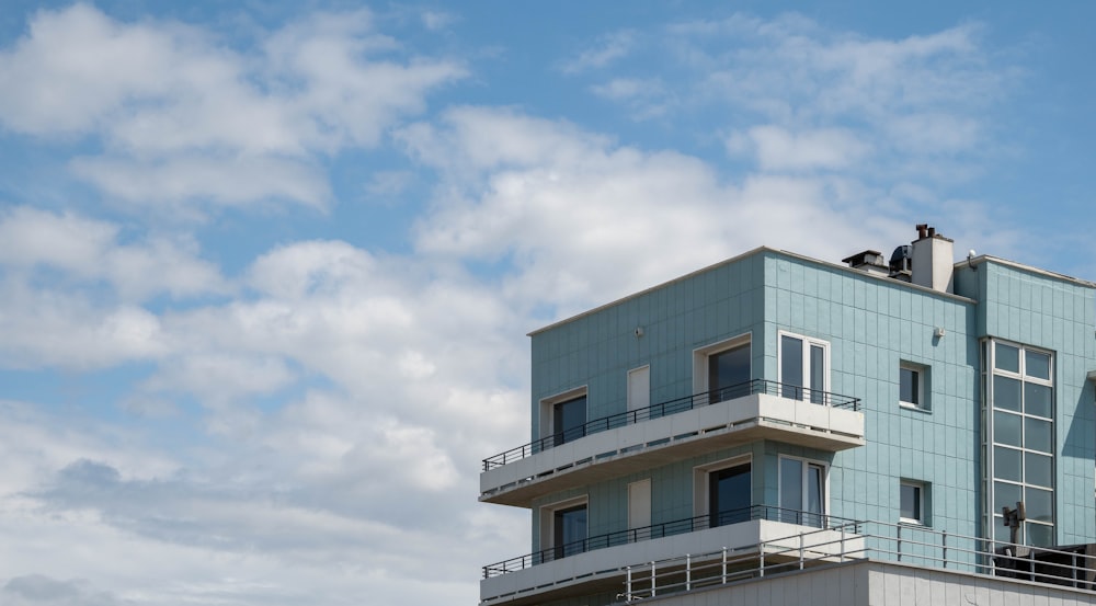 a tall building with balconies on top of it