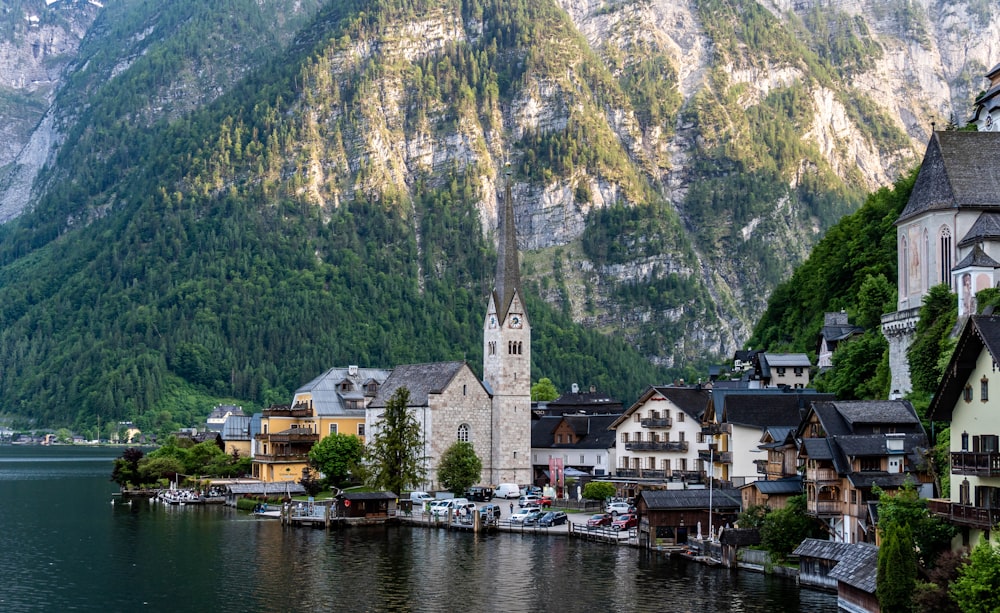 a village on a lake with mountains in the background