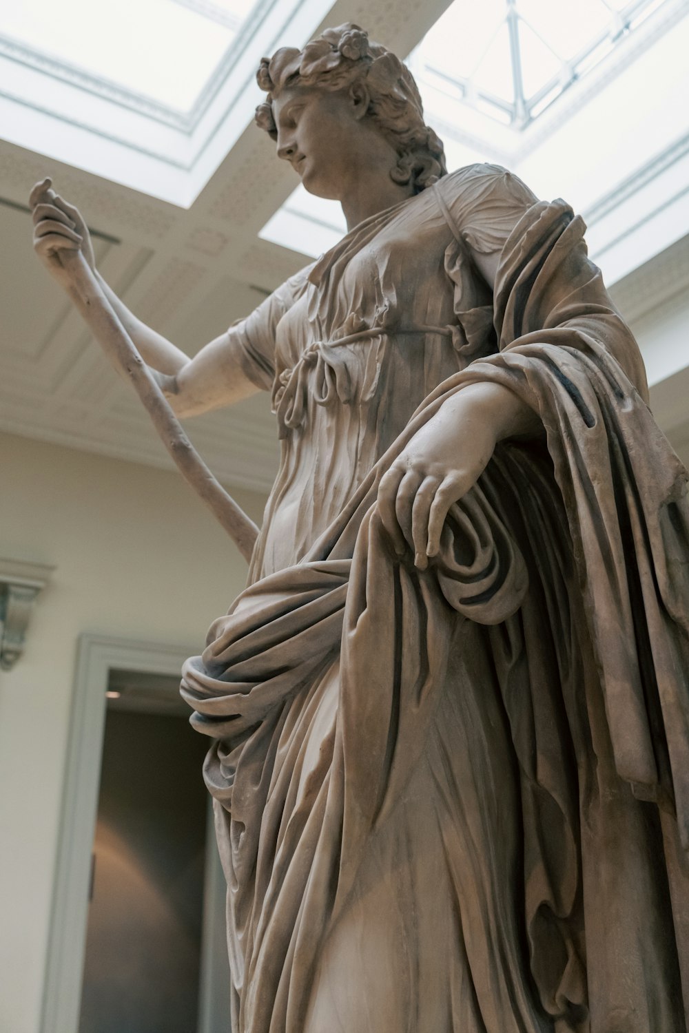 a statue of a woman holding a staff