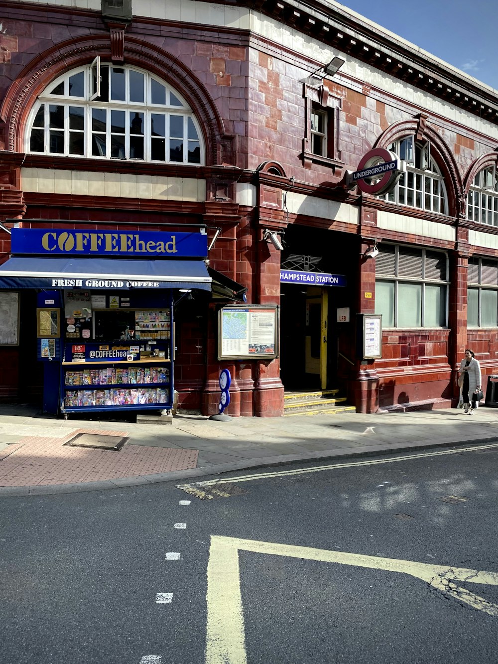 a red brick building with a blue awning