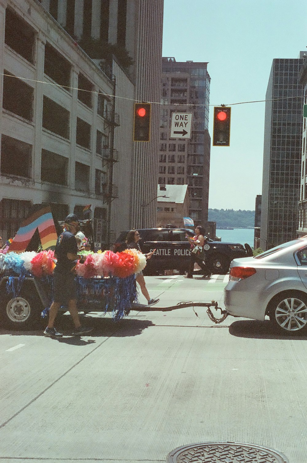 a person pulling a cart with balloons on a city street